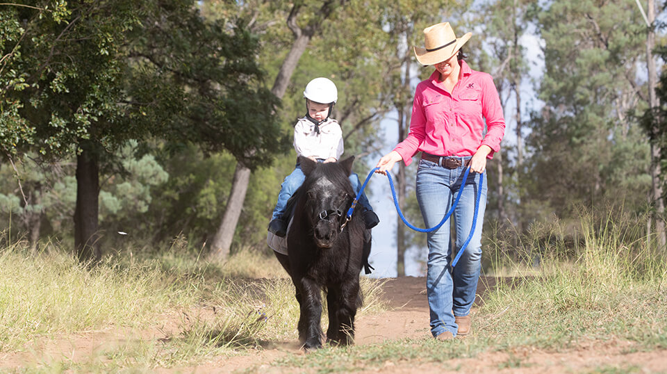 Kate leading her son on his pony